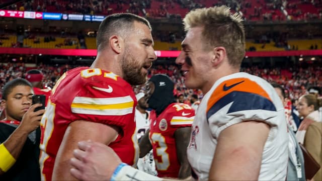 Denver Broncos quarterback Bo Nix (10) and Kansas City Chiefs tight end Travis Kelce (87) after the game at GEHA Field at Arrowhead Stadium.
