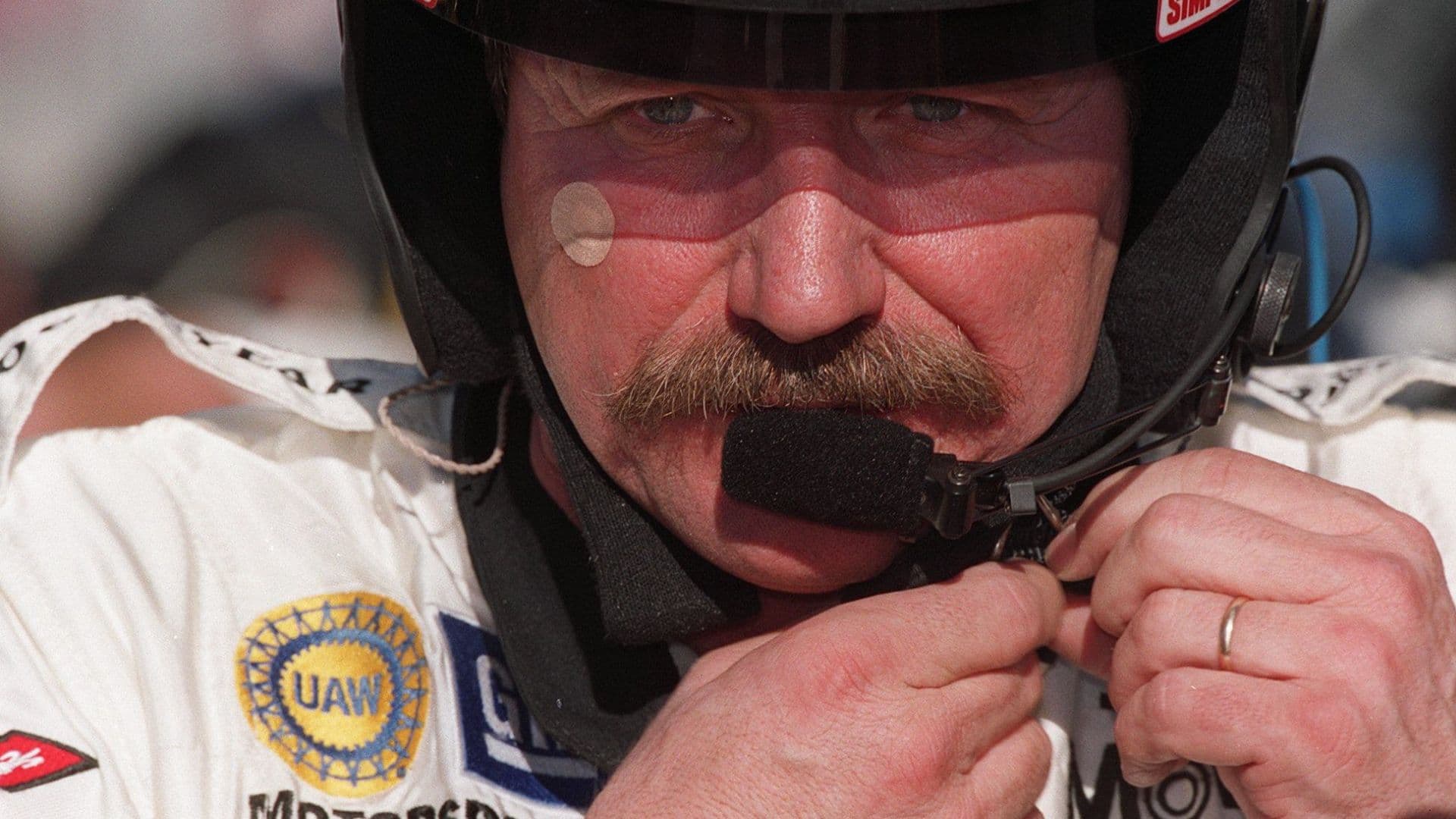 Dale Earnhardt, Sr. adjusts his helmet during testing at the Daytona International Speedway, January 5, 2001.