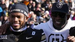 Colorado Buffaloes safety Shilo Sanders (21) and head coach Deion Sanders and quarterback Shedeur Sanders (2) and social media producer Deion Sanders Jr. following the win against the Oklahoma State Cowboys at Folsom Field.