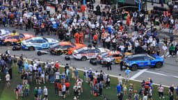 Feb 16, 2025; Daytona Beach, Florida, USA; NASCAR fans participate in pre race activities on pit row before the Daytona 500 at Daytona International Speedway.