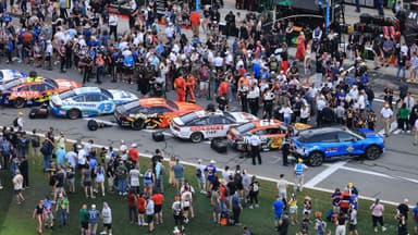 Feb 16, 2025; Daytona Beach, Florida, USA; NASCAR fans participate in pre race activities on pit row before the Daytona 500 at Daytona International Speedway.
