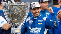 Nov 2, 2025; Avondale, Arizona, USA; NASCAR Cup Series driver Kyle Larson (5) celebrates with the Bill France Cup trophy after clinching the 2025 NASCAR Cup Series Championship following the NASCAR Championship race at Phoenix Raceway.