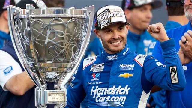 Nov 2, 2025; Avondale, Arizona, USA; NASCAR Cup Series driver Kyle Larson (5) celebrates with the Bill France Cup trophy after clinching the 2025 NASCAR Cup Series Championship following the NASCAR Championship race at Phoenix Raceway.