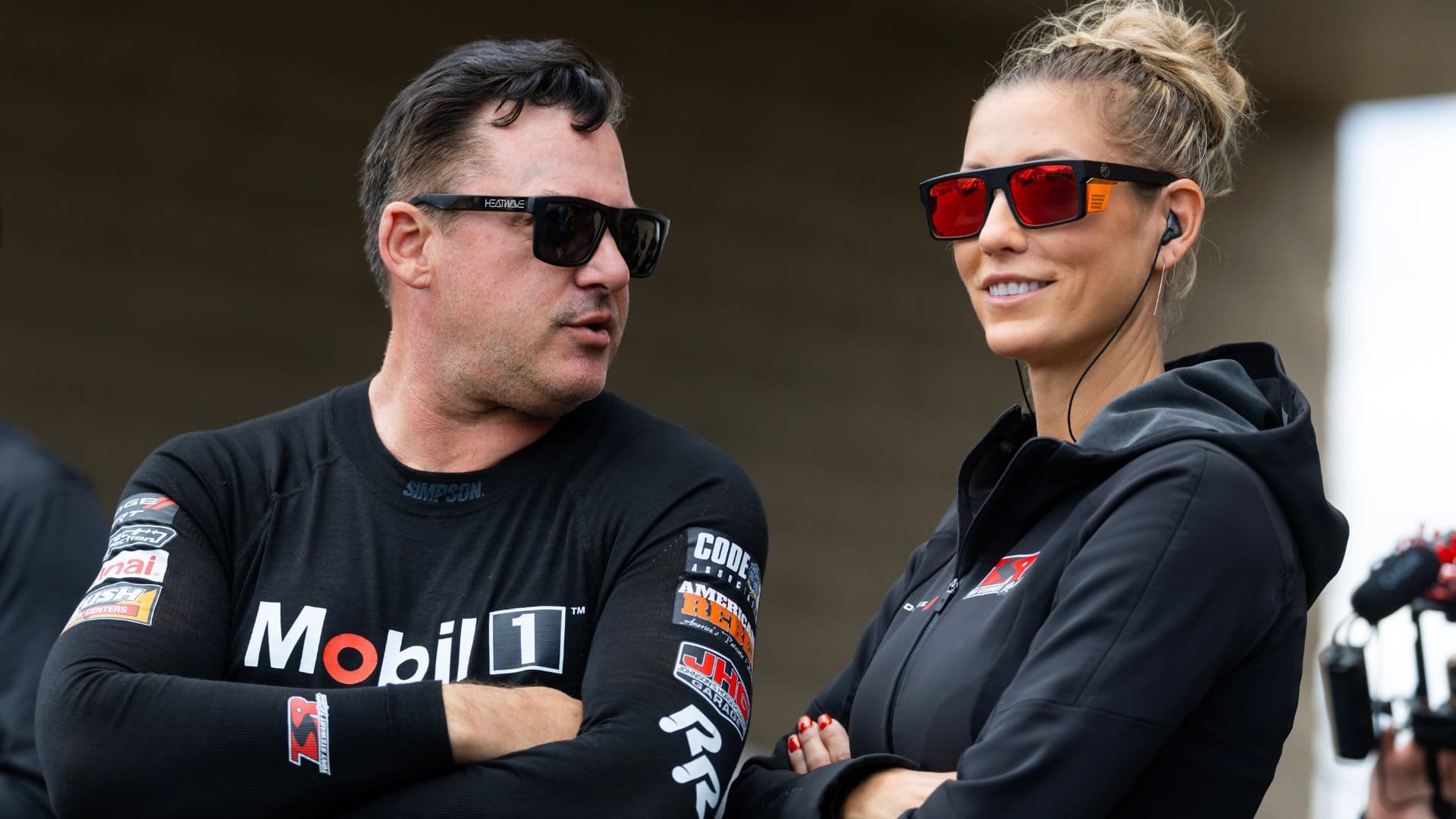 May 18, 2025; Joliet, IL, USA; NHRA top fuel driver Tony Stewart (left) with wife Leah Pruett during the Route 66 Nationals at Route 66 Raceway.