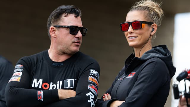 May 18, 2025; Joliet, IL, USA; NHRA top fuel driver Tony Stewart (left) with wife Leah Pruett during the Route 66 Nationals at Route 66 Raceway.