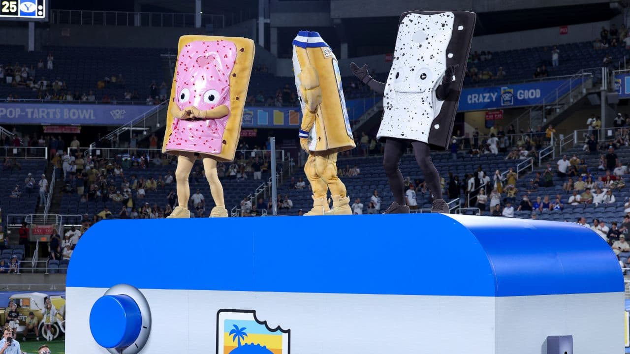 Pop-Tarts mascots celebrate with BYU Cougars after beating Georgia Tech Yellow Jackets in the Pop-Tarts Bowl at Camping World Stadium.