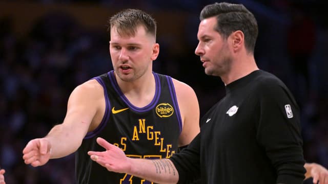 Los Angeles Lakers guard Luka Doncic (77) talks with head coach JJ Redick during a time out in the second half against the Memphis Grizzlies at Crypto.com Arena.
