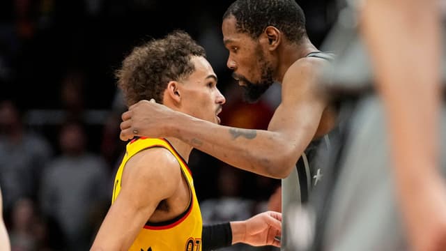 Apr 2, 2022; Atlanta, Georgia, USA; Atlanta Hawks guard Trae Young (11) (left) and Brooklyn Nets forward Kevin Durant (7) react after the Hawks defeated the Nets at State Farm Arena.