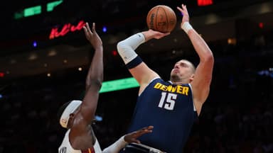 Denver Nuggets center Nikola Jokic (15) shoots the basketball over Miami Heat center Bam Adebayo (13) during the first quarter at Kaseya Center