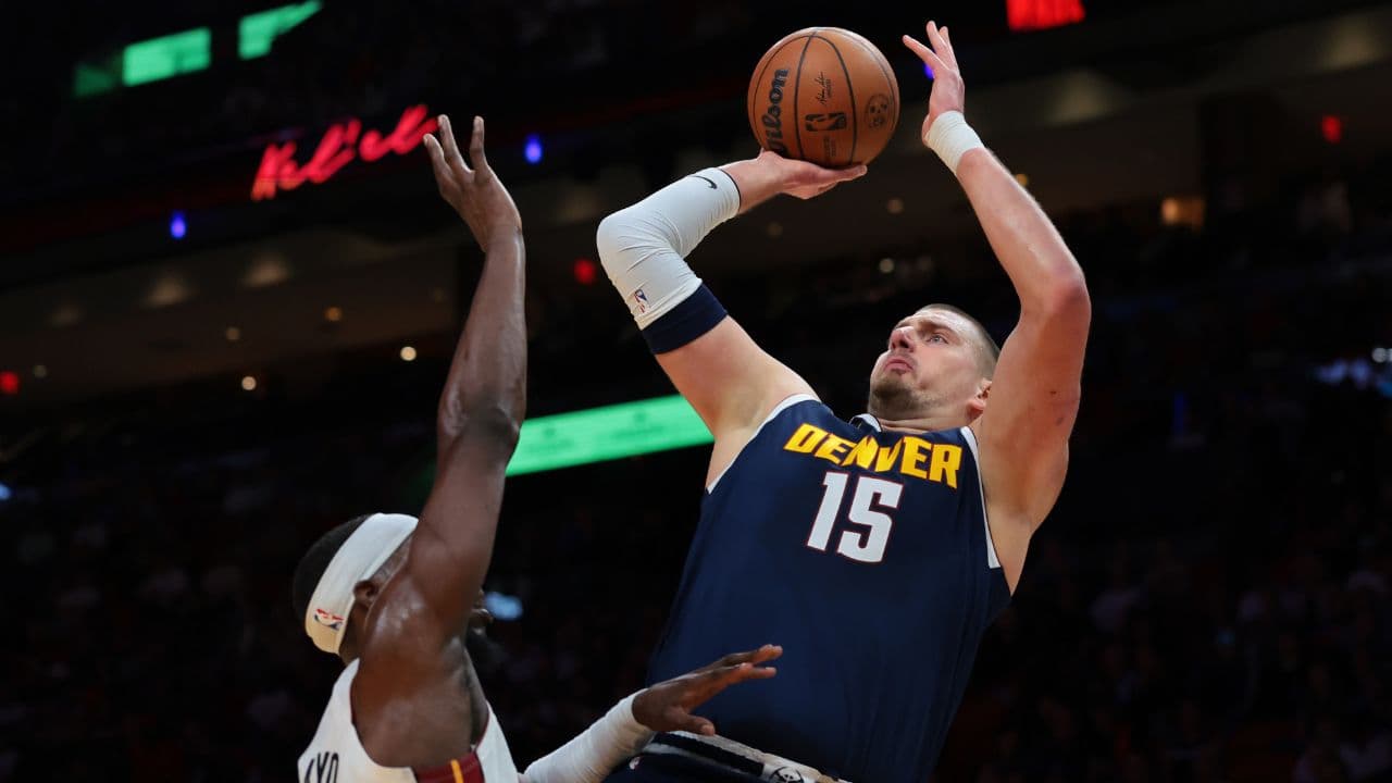 Denver Nuggets center Nikola Jokic (15) shoots the basketball over Miami Heat center Bam Adebayo (13) during the first quarter at Kaseya Center