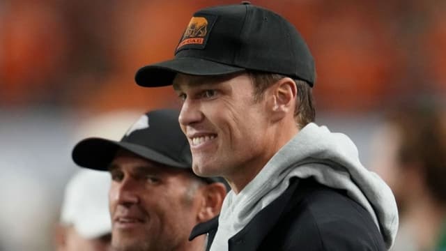 Jan 19, 2026; Miami Gardens, FL, USA; Tom Brady looks on from the sideline before the CFP National Championship college football game between the Indiana Hoosiers and the Miami Hurricanes at Hard Rock Stadium. Mandatory Credit: Kirby Lee-Imagn Images