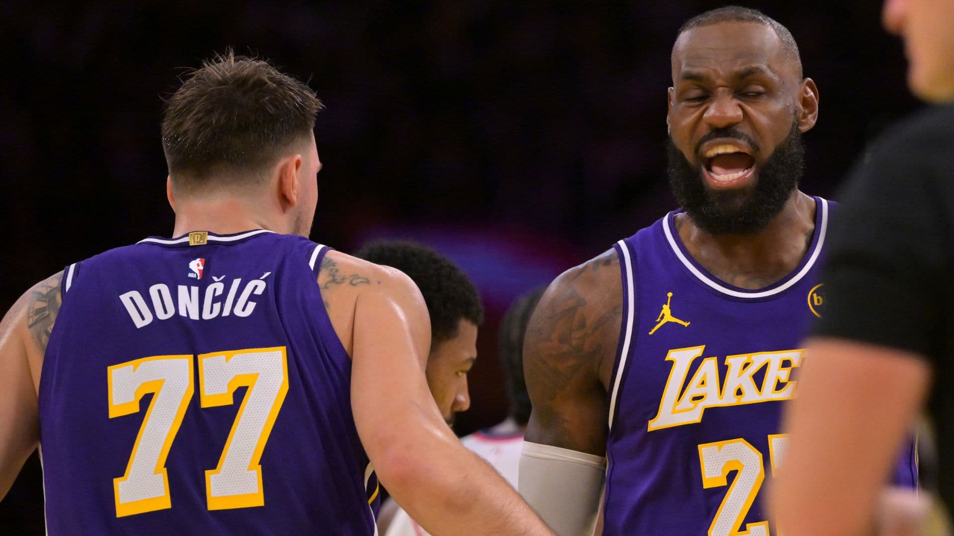 Nov 25, 2025; Los Angeles, California, USA; Los Angeles Lakers guard Luka Doncic (77) and forward LeBron James (23) react after a foul during the first half against the Los Angeles Clippers at Crypto.com Arena