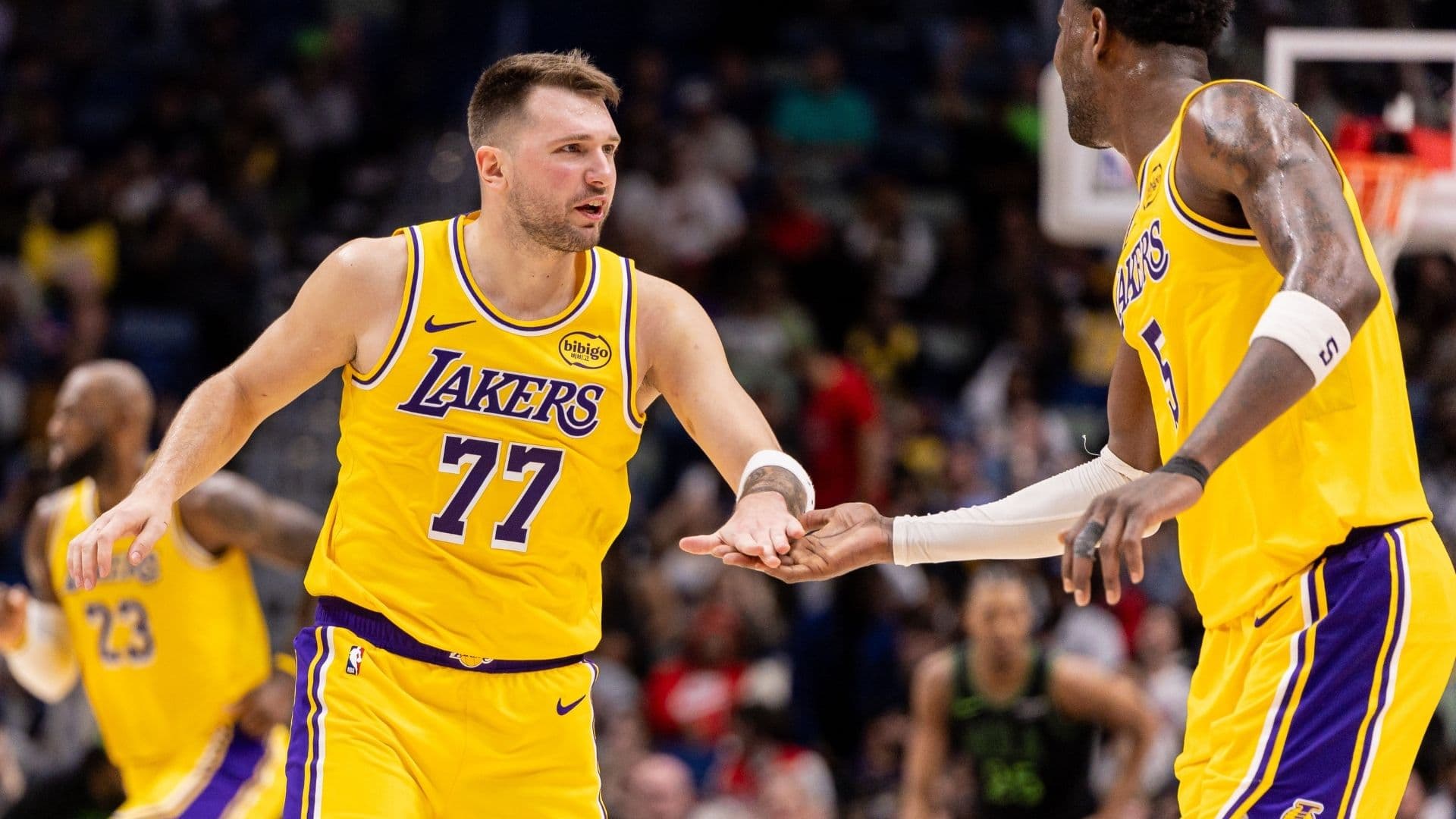 Jan 6, 2026; New Orleans, Louisiana, USA; Los Angeles Lakers forward/guard Luka Doncic (77) slaps hands with center Deandre Ayton (5) after a play against the New Orleans Pelicans during the second half at Smoothie King Center.