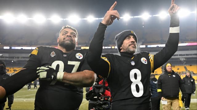 Pittsburgh Steelers quarterback Aaron Rodgers (8) and defensive tackle Cameron Heyward (97) celebrate after defeating the Baltimore Ravens at Acrisure Stadium.