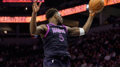 Jan 25, 2026; Minneapolis, Minnesota, USA; Minnesota Timberwolves guard Anthony Edwards (5) secures a rebound in the fourth quarter against the Golden State Warriors at Target Center.