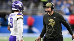Minnesota Vikings head coach Kevin O'Connell greets quarterback J.J. McCarthy (9) after throwing a touchdown pass in the first quarter at Ford Field.