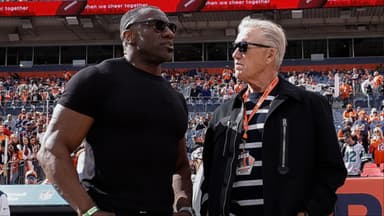 Former Denver Broncos player Shannon Sharpe (L) talks with the Broncos Director of Football Operations, John Elway (C) and former quarterback Peyton Manning (R) before the game against the New York Jets at Empower Field at Mile High.