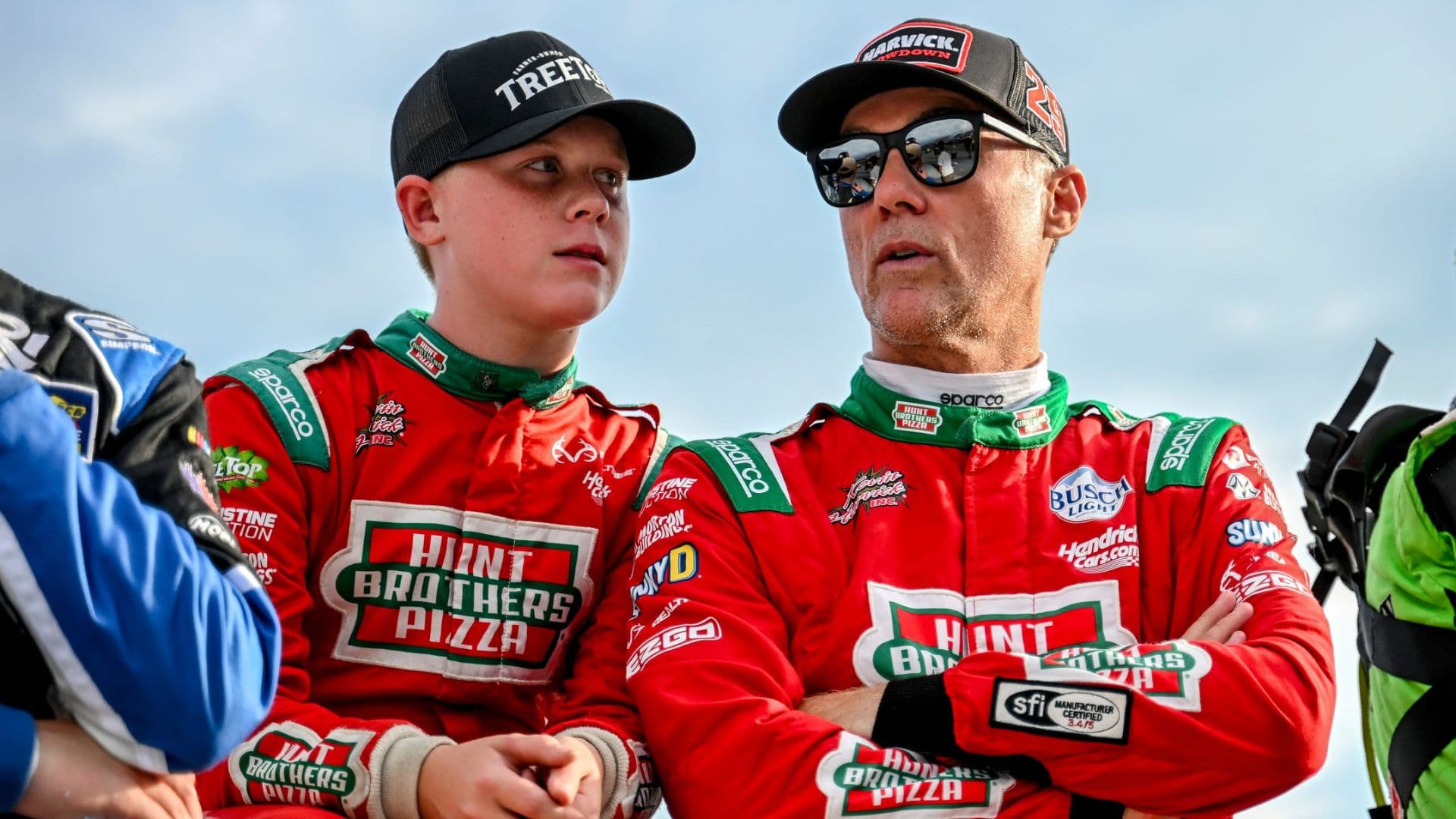 Former NASCAR Cup Series champion Kevin Harvick, center, right, and his son Keelan, 13, look on before the two raced in the 13th annual Masters of the Pros 200 race on Wednesday, July 16, 2025, at the Owosso Speedway.