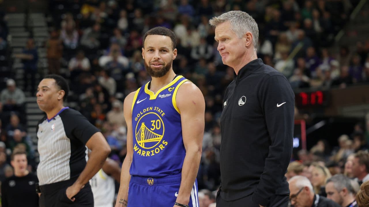 Golden State Warriors guard Stephen Curry (30) and head coach Steve Kerr talk on the sideline during the first quarter against the Utah Jazz at Delta Center.