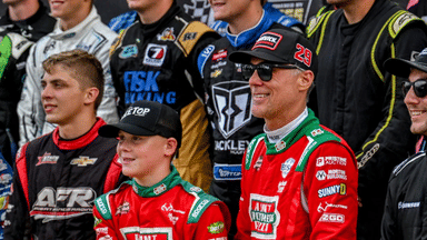Former NASCAR Cup Series champion Kevin Harvick, center, and his 13-year-old son Keelan, left, pose with other drivers before the 13th annual Masters of the Pros 200 race on Wednesday, July 16, 2025, at the Owosso Speedway.