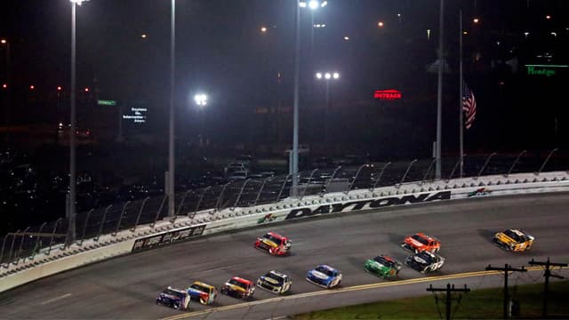 Feb 14, 2021; Daytona Beach, Florida, USA; NASCAR Cup Series driver Denny Hamlin (11) leads the field in turn four during the Daytona 500 at Daytona International Speedway.