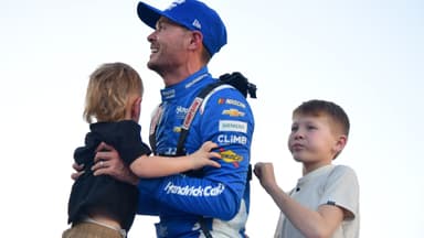 Nov 2, 2025; Avondale, Arizona, USA; NASCAR Cup Series driver Kyle Larson (5) celebrates his championship victory with son Cooper and Owen following the Cup Series Championship race at Phoenix Raceway