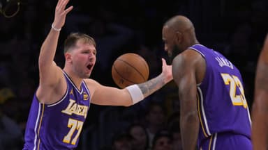 Dec 10, 2025; Los Angeles, California, USA; Los Angeles Lakers guard Luka Doncic (77) and forward Lebron James (23) react after a foul call during the second half against the San Antonio Spurs at Crypto.com Arena.