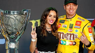Nov 17, 2019; Homestead, FL, USA; NASCAR Cup Series driver Kyle Busch (18) celebrates after winning the NASCAR Series Cup Championship with his wife Samantha Busch after the Ford EcoBoost 400 at Homestead-Miami Speedway.