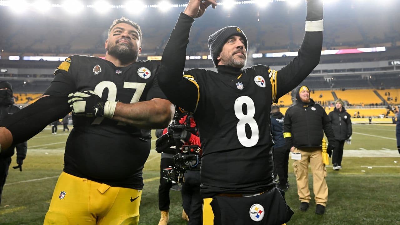 Pittsburgh Steelers quarterback Aaron Rodgers (8) and defensive tackle Cameron Heyward (97) celebrate after defeating the Baltimore Ravens at Acrisure Stadium.
