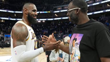 Jan 25, 2025; San Francisco, California, USA; Los Angeles Lakers forward LeBron James (left) talks with Golden State Warriors forward Draymond Green (right) after the game at Chase Center.