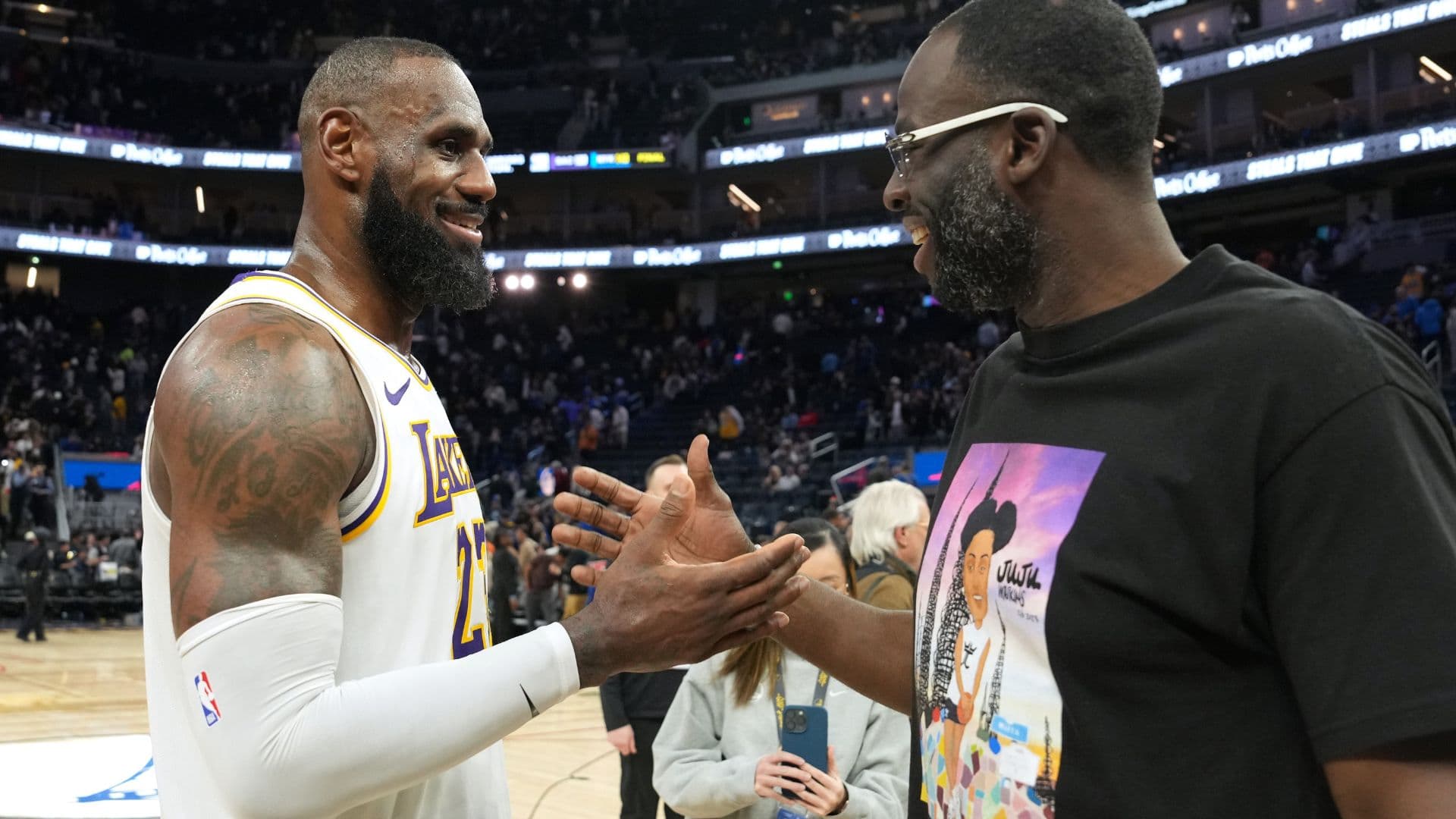 Jan 25, 2025; San Francisco, California, USA; Los Angeles Lakers forward LeBron James (left) talks with Golden State Warriors forward Draymond Green (right) after the game at Chase Center.