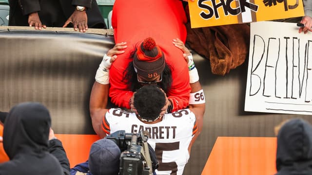 Cleveland Browns defensive end Myles Garrett (95) greets family following a victory against the Cincinnati Bengals at Paycor Stadium.