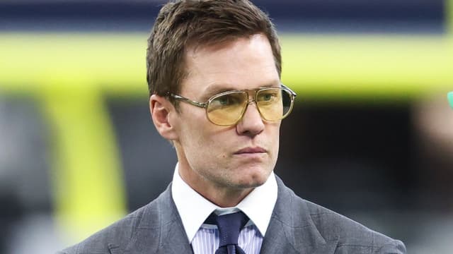 Former NFL quarterback Tom Brady looks on from the sideline before the game between the Philadelphia Eagles and Dallas Cowboys at AT&T Stadium.
