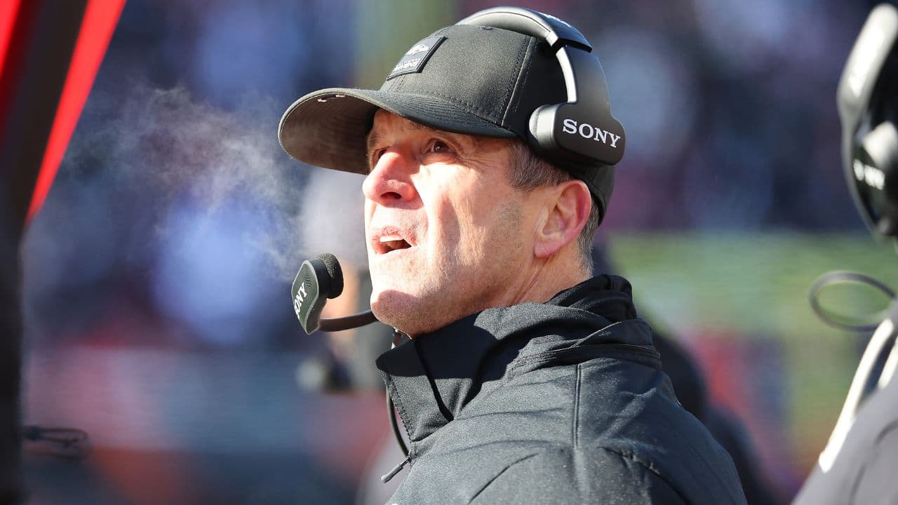 Baltimore Ravens head coach John Harbaugh checks a replay during the second quarter against the Cincinnati Bengals at Paycor Stadium.