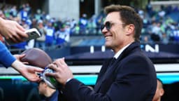 Tom Brady signs autographs before the 2026 NFC Championship Game between the Seattle Seahawks and the Los Angeles Rams at Lumen Field.