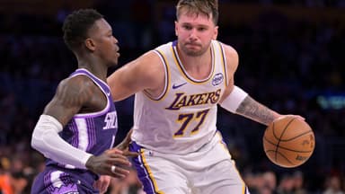 Dec 28, 2025; Los Angeles, California, USA; Sacramento Kings guard Dennis Schroder (17) defemds Los Angeles Lakers guard Luka Doncic (77) in the second half at Crypto.com Arena.