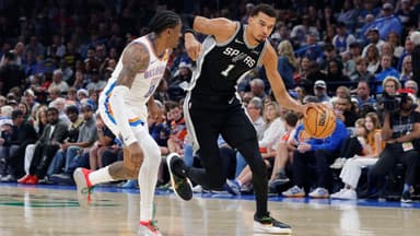 Dec 25, 2025; Oklahoma City, Oklahoma, USA; San Antonio Spurs forward Victor Wembanyama (1) drives down the court beside Oklahoma City Thunder guard Jalen Williams (8) during the second quarter at Paycom Center