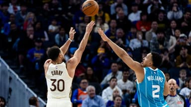 Golden State Warriors guard Stephen Curry (30) takes a three-point shot as Charlotte Hornets forward Grant Williams (2) defends during the third quarter at Chase Center