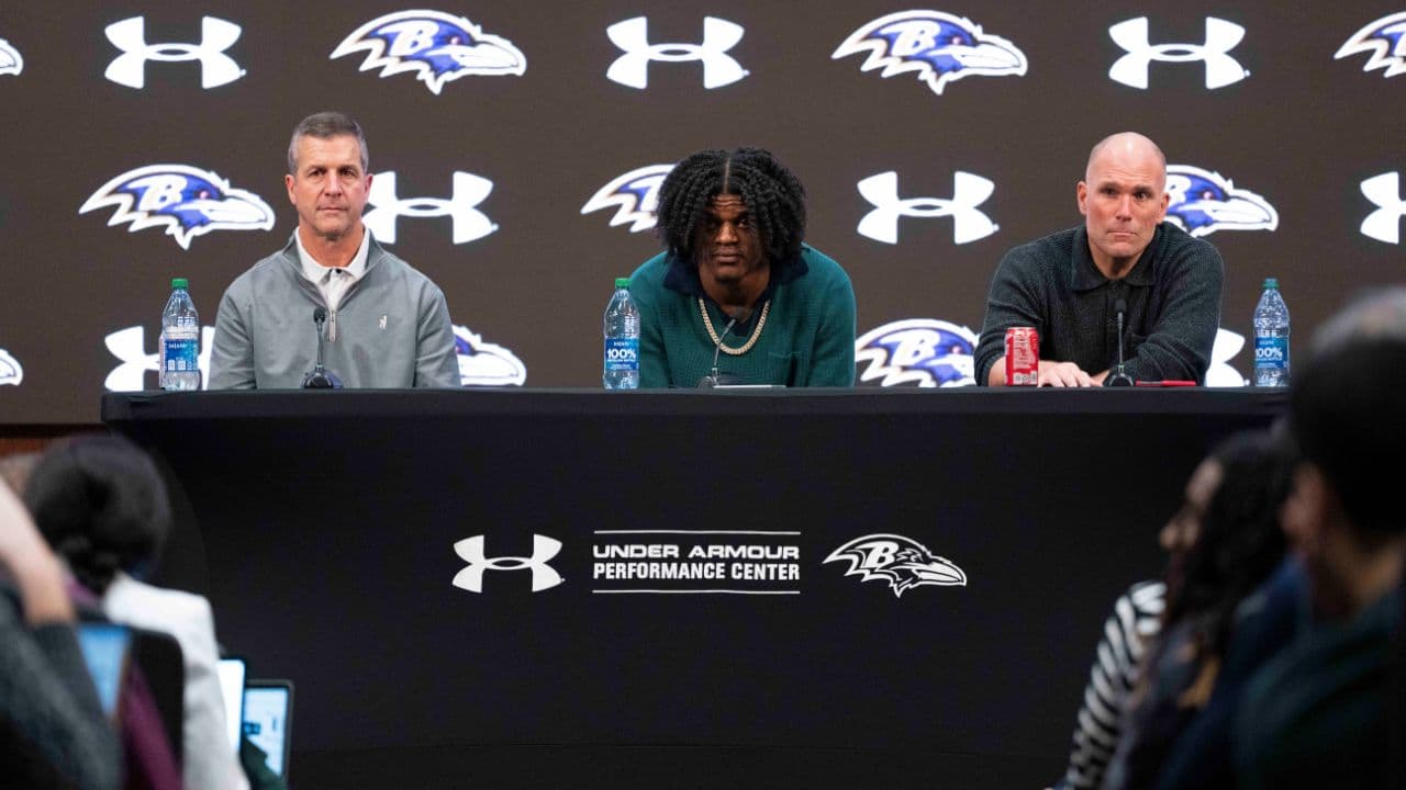 Baltimore Ravens head coach John Harbaugh, quarterback Lamar Jackson, and general manager Eric DeCosta listen to a question asked at a press conference at Under Armour Performance Center.