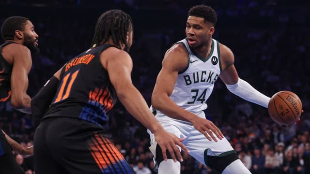 Nov 28, 2025; New York, New York, USA; Milwaukee Bucks forward Giannis Antetokounmpo (34) dribbles as New York Knicks guard Jalen Brunson (11) defends during the first half at Madison Square Garden. Mandatory Credit: Vincent Carchietta-Imagn Images