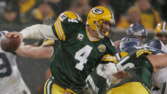 Green Bay Packers quarterback Brett Favre has to scramble but makes it outside to complete a shovel pass to Donald Lee during the second quarter of the Green Bay Packers and Seattle Seahawks NFL playoff game on Saturday, Jan. 12, 2008, at Lambeau Field.