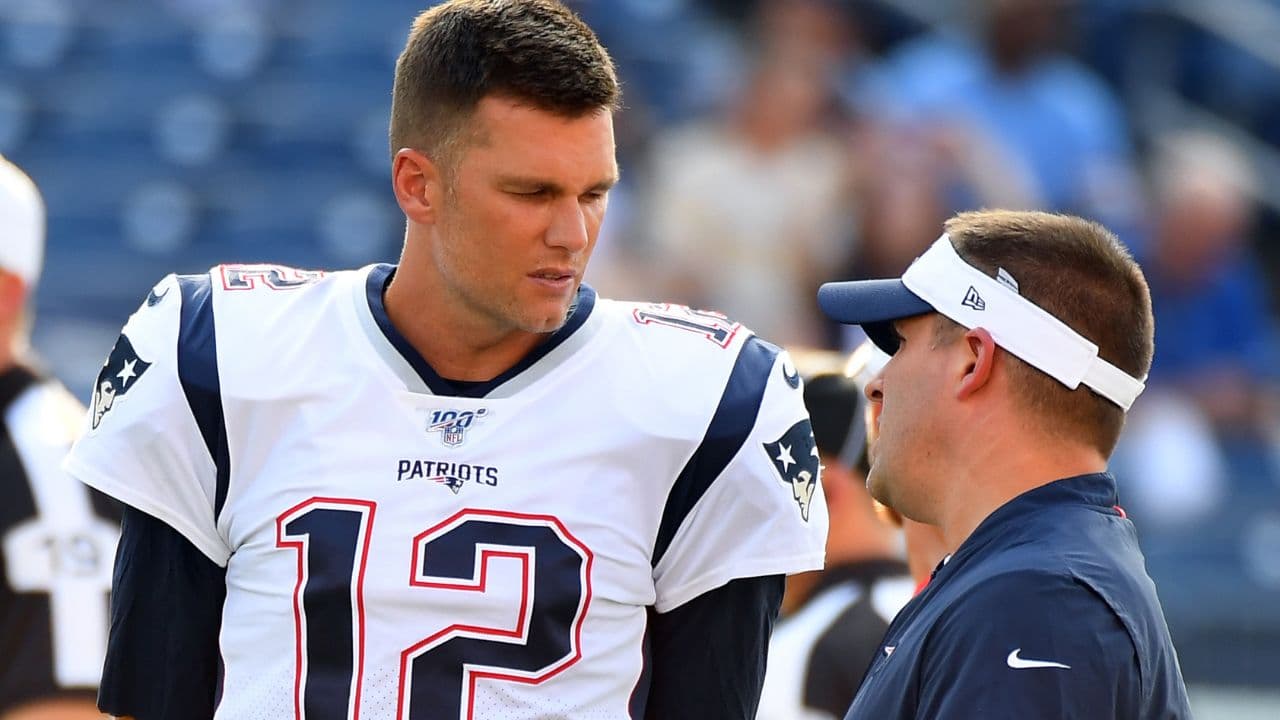 New England Patriots quarterback Tom Brady (12) talks with New England Patriots offense coordinator Josh McDaniels before the game against the Tennessee Titans at Nissan Stadium. Mandatory