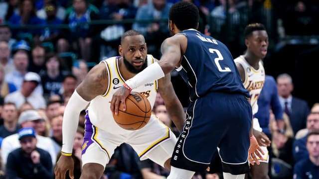 Los Angeles Lakers forward LeBron James (6) guards Dallas Mavericks guard Kyrie Irving (2) during the fourth quarter at American Airlines Center.