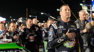 Kyle Busch stands for the national anthem before the NASCAR Cup Series Duel during Speedweek, Thursday, Feb. 12, 2026.
