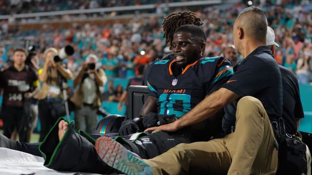 Miami Dolphins wide receiver Tyreek Hill (10) reacts after being placed on a medical cart against the New York Jets during the second half at Hard Rock Stadium.
