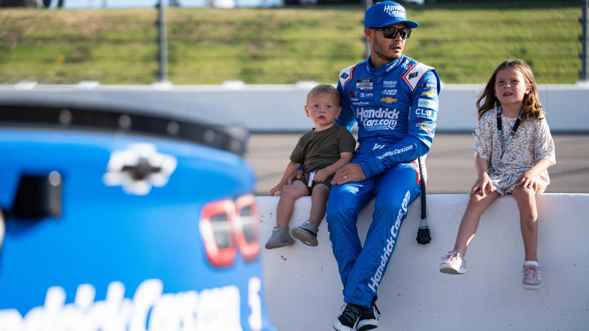 NASCAR Cup Series driver Kyle Larson sits with his children before the start of the race on Sunday, June 16, 2024, at the Iowa Speedway in Newton.