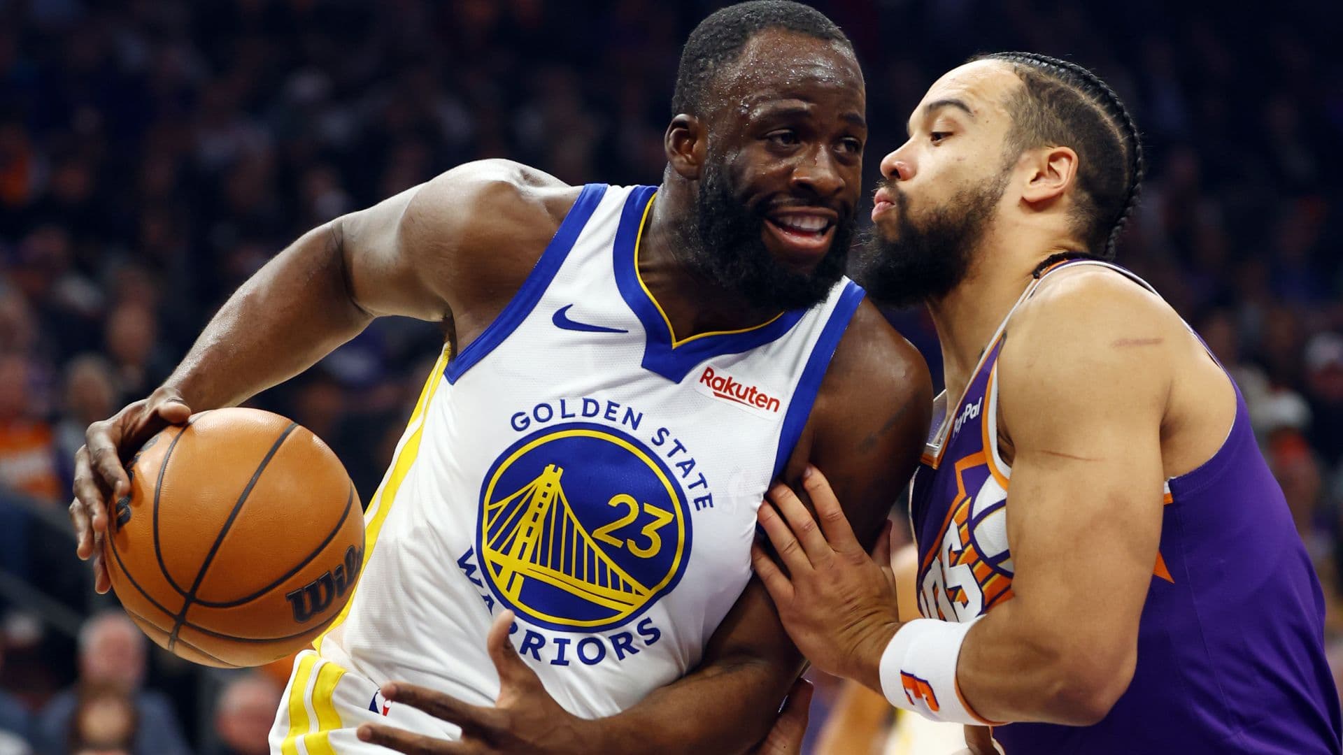 Dec 18, 2025; Phoenix, Arizona, USA; Golden State Warriors forward Draymond Green (23) against Phoenix Suns forward Dillon Brooks in the first half at Mortgage Matchup Center.