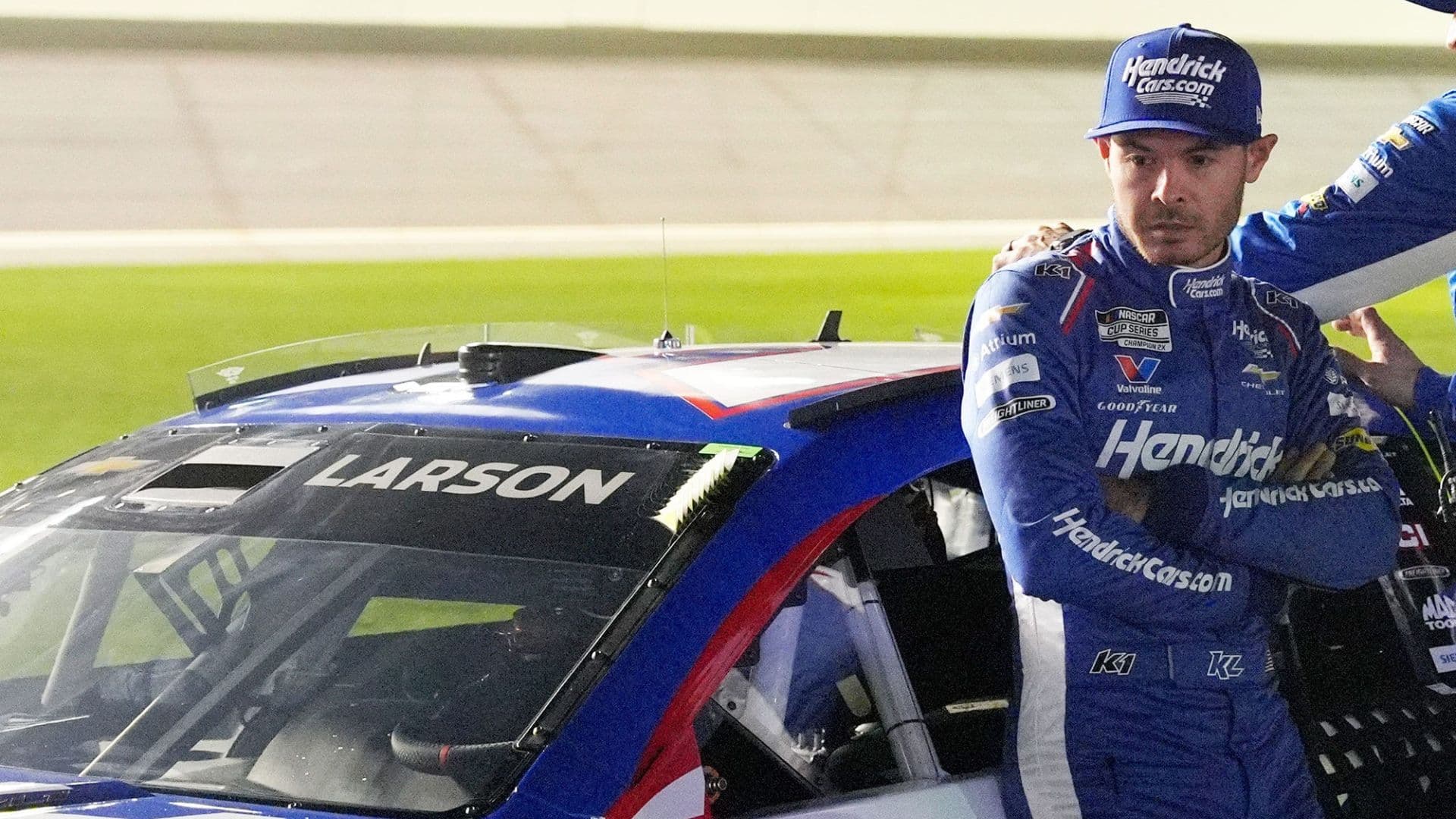 Kyle Larson waits by his car before the NASCAR Cup Series Duel during Speedweek, Thursday, Feb. 12, 2026.