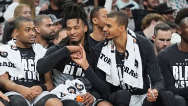 Feb 7, 2026; San Antonio, Texas, USA; San Antonio Spurs forward Victor Wembanyama (1) shakes the hand of guard Stephon Castle (5) during the second half against Dallas Mavericks at Frost Bank Center.
