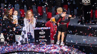 Feb 15, 2026; Daytona Beach, Florida, USA; NASCAR Cup Series driver Tyler Reddick (45) celebrates with son Beau Reddick as wife Alexa DeLeon holds son Rookie Reddick in victory lane after winning the 68th running of the Daytona 500 at Daytona International Speedway